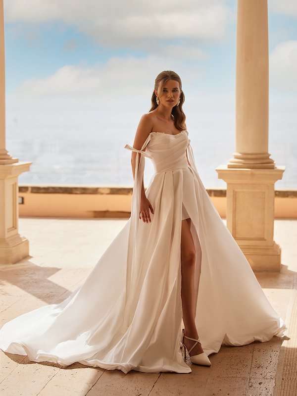 Bride Wearing A Taffeta Full A-line Wedding Dress With Pleated Bodice and Front Leg slit