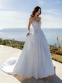 Sophisticated bride in Moonlight Couture H1588 a Mikado wedding dress featuring beaded lace bodice, strapless sweetheart neckline, and pockets