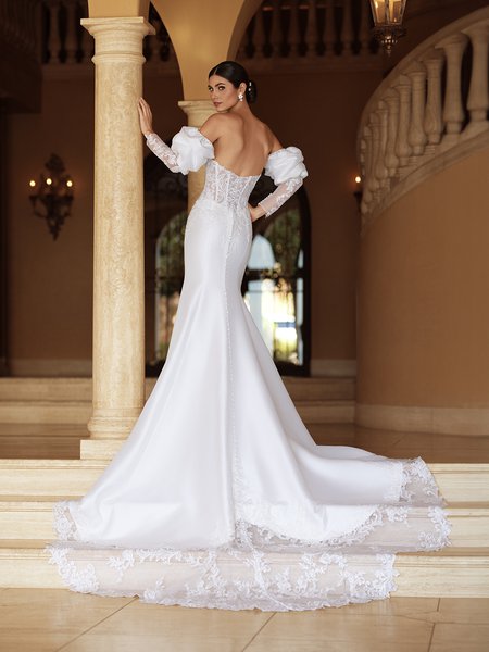 Luxurious Mikado Moonlight Couture H1589 is a wedding gown with illusion lace back, cutout train, and puff sleeves