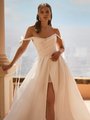 Closeup Of Bride In Ivory Wedding Dress With Pointed Sweetheart Neckline and Off Shoulder Bow Sleeves