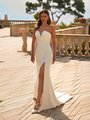 Bride wearing strapless pointed sweetheart neckline wedding dress with pleated bodice and leg slit