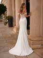 Back view of bride's sweep train crepe wedding dress with illusion lace details 