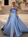 Bride in front of building walking in a light blue Mikado A-line wedding dress with leg slit and floral off the shoulder neckline